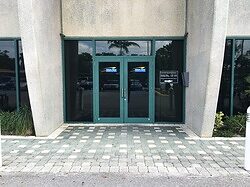 Commercial storefront glass doors with window film in Miami