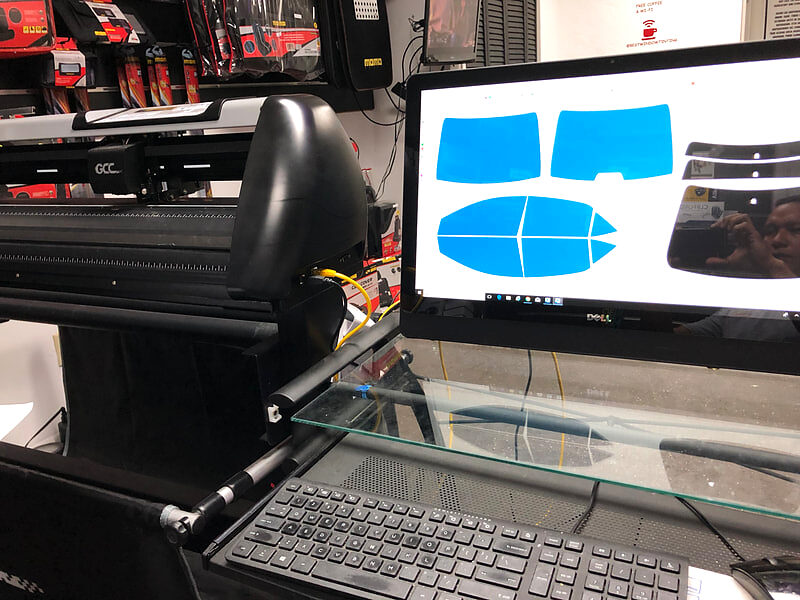 Computer-cut window film patterns being plotted for a customer vehicle