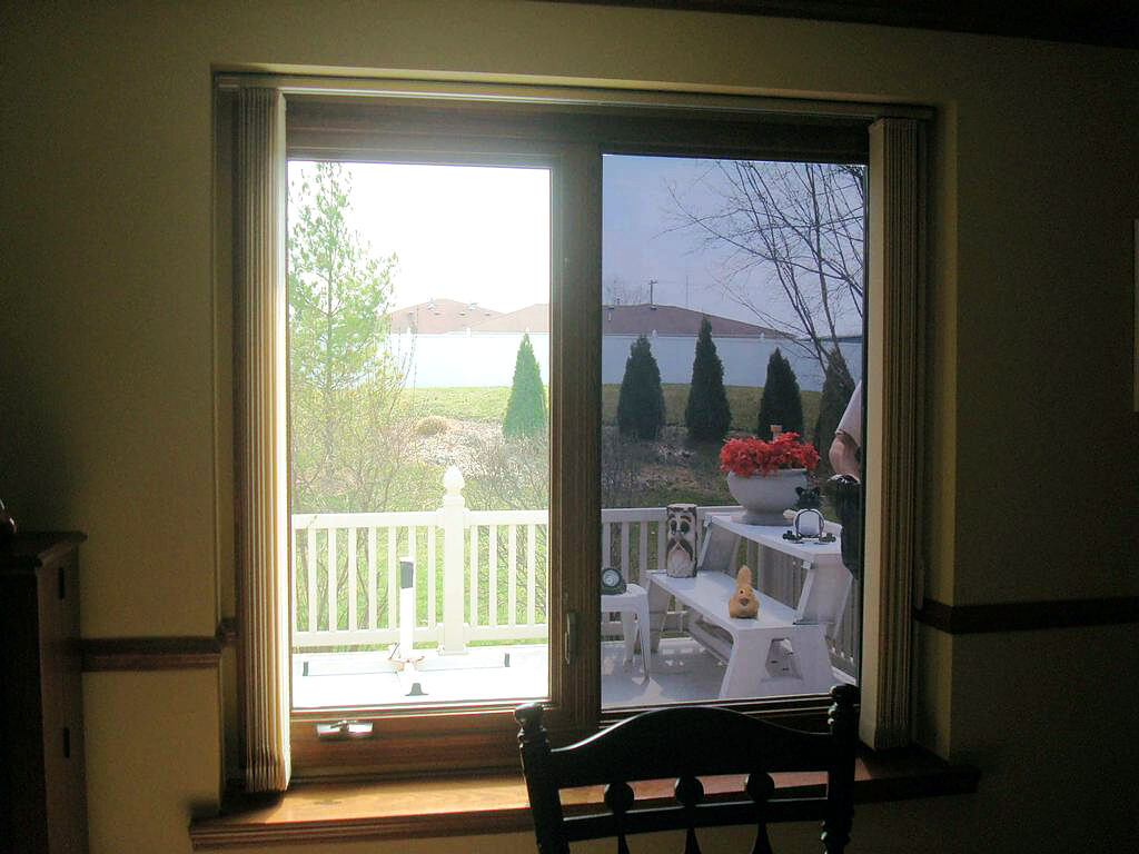 Patio doors with heat-reducing residential window film