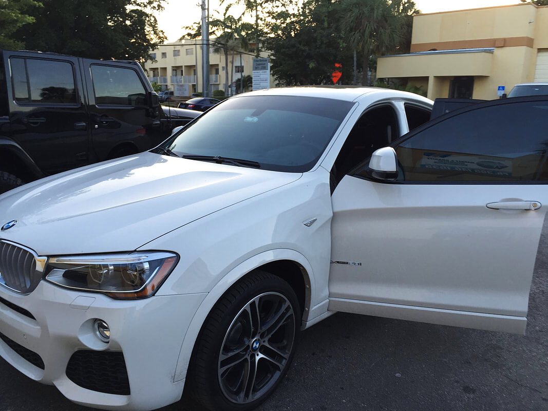White BMW X4 with ceramic window tint in Miami FL