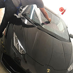Paint protection film being applied to a Lamborghini in Miami