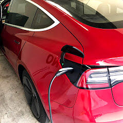Red Tesla Model 3 with tinted windows in Miami